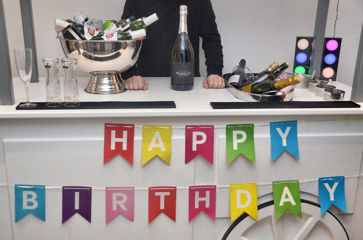 Drinks bar with drinks and Happy Birthday banner