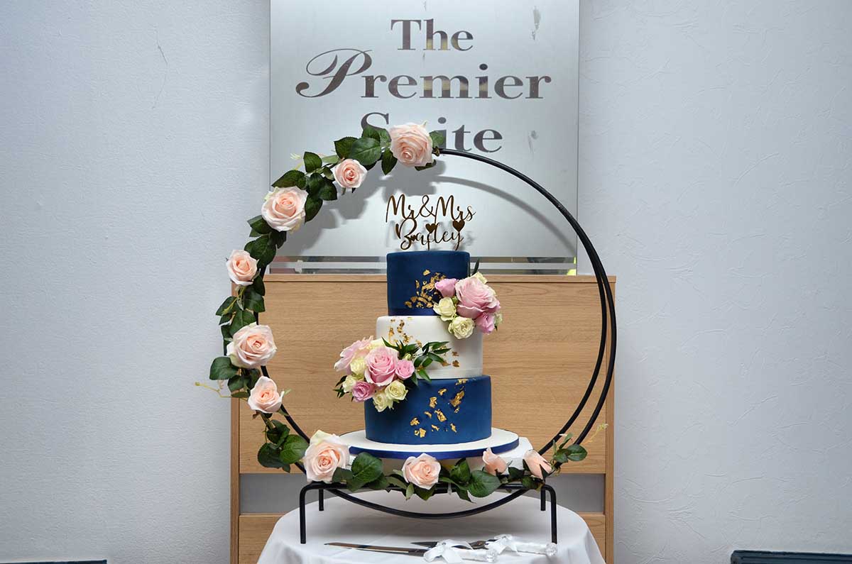 Hoop Cake stand with navy blue and dusty pink theme floral garland