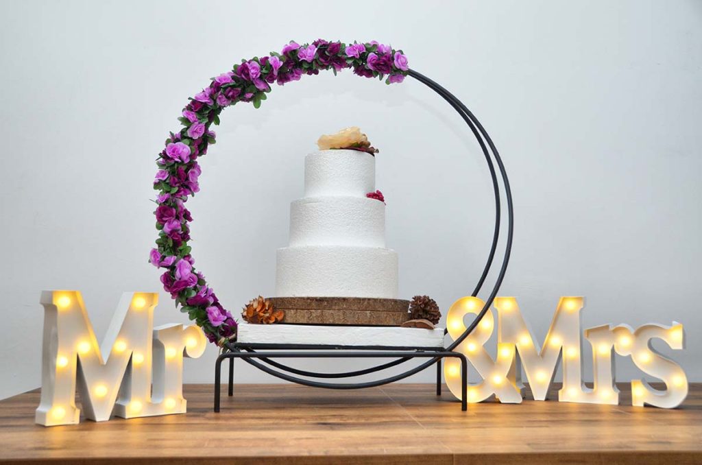 Hoop cake stand with light up MR & MRS letters and purple garland