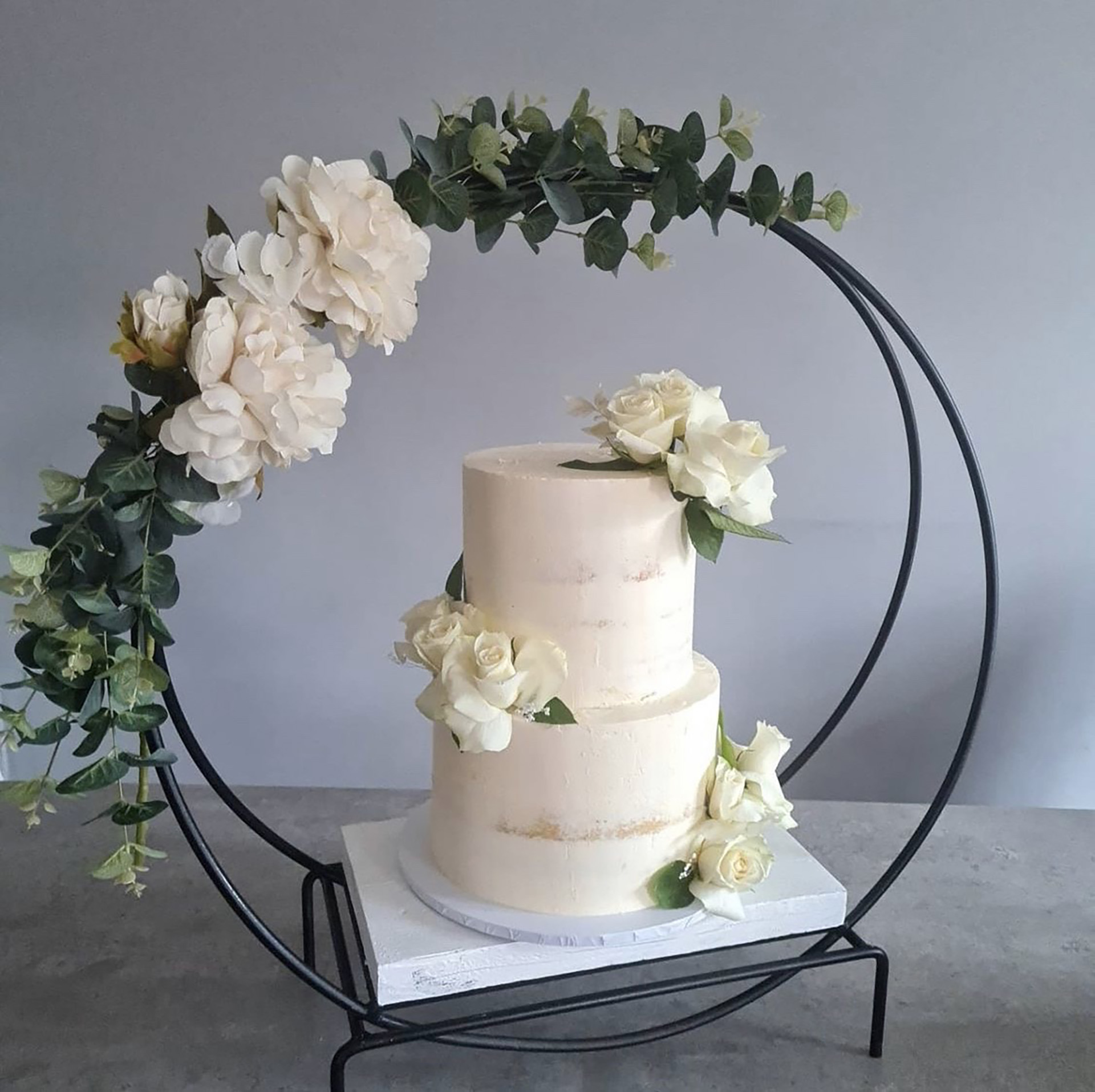 Cake stand with hoop on a sturdy surface with 2 tier cake
