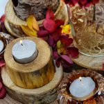 Rustic table centrepieces with candles and flowers
