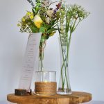 Rustic table stand centrepiece with bud vases, flower stems and candleholder