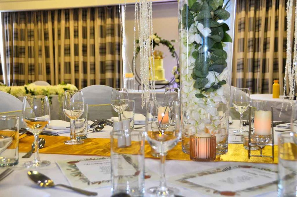 Dinner plates, cutlery and drinking glasses at an event