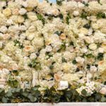 Luxury flower wall backdrop with lush white roses, for weddings and events.