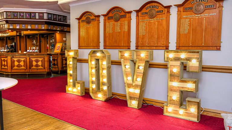 Free-standing rustic LED LOVE letters in the function room at Denton Golf Club