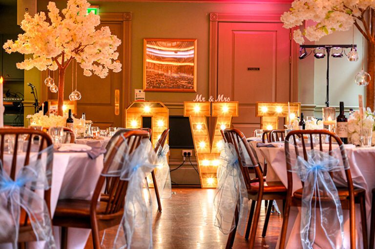 Elegant wedding reception table styling with blossom tree and a floral wreath centrepieces